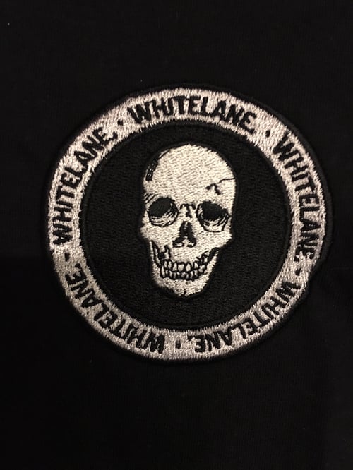 Image of Whitelane. Skull emblem tee