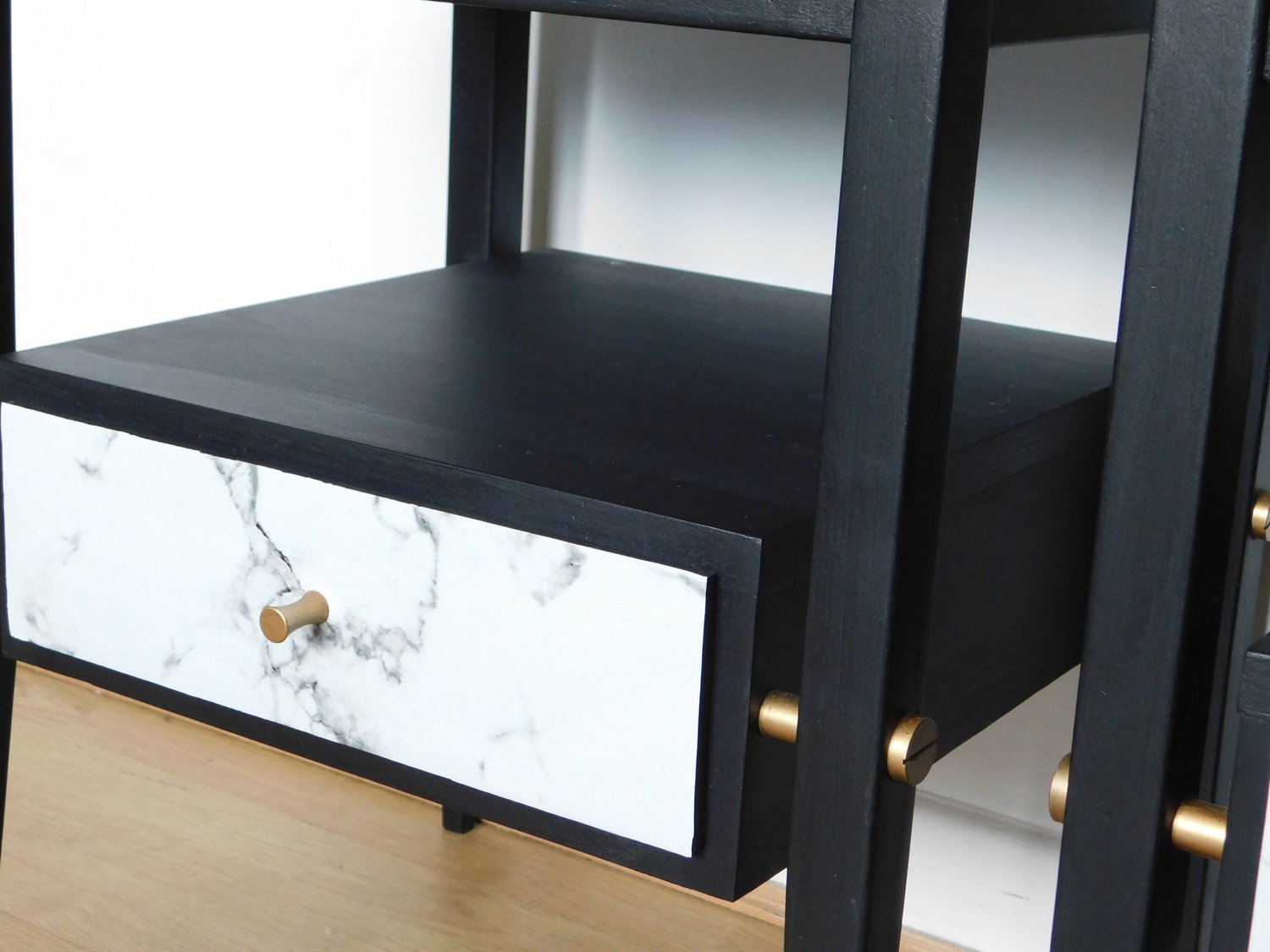 Image of A pair of black, gold and marble bedside tables