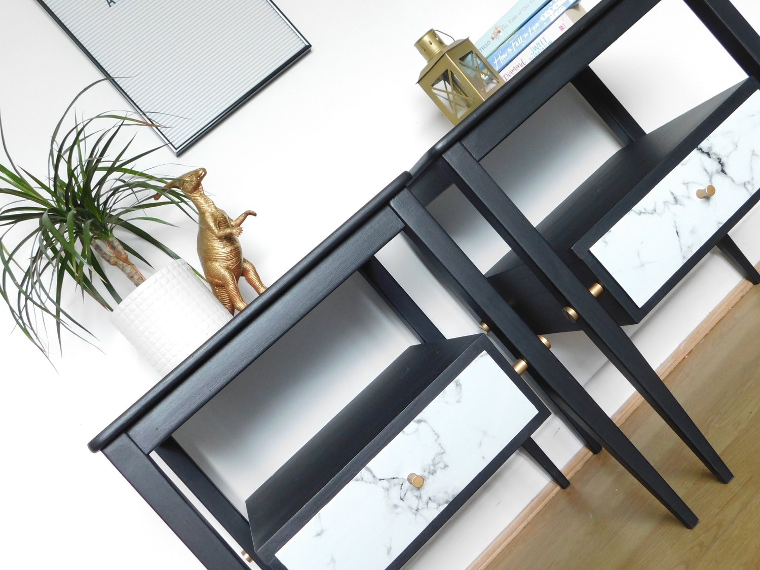 Image of A pair of black, gold and marble bedside tables