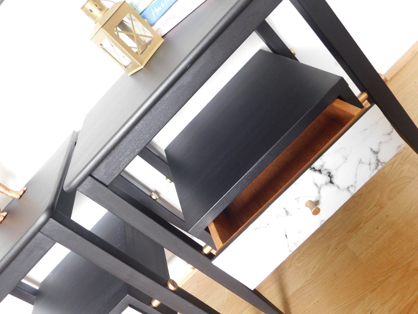 Image of A pair of black, gold and marble bedside tables