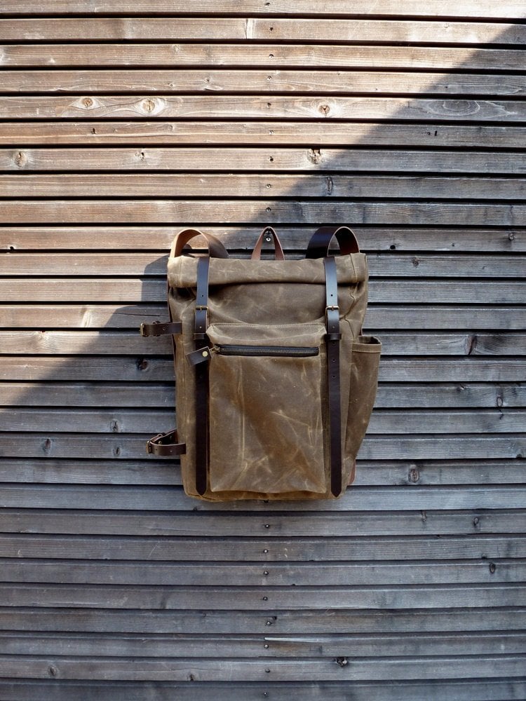Image of Waxed canvas backpack with roll to close top and vegetable tanned leather shoulderstrap and back rei