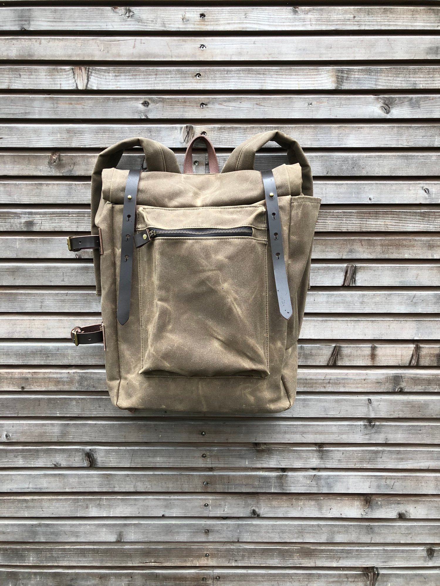 Image of Waxed canvas backpack with roll to close top and vegetable tanned leather shoulderstrap and back rei