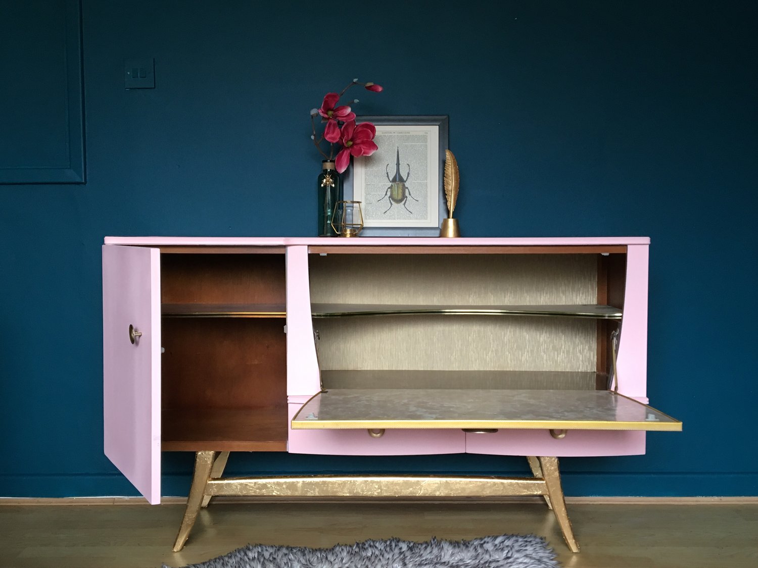 Image of A mid century modern drinks sideboard in pink & gold