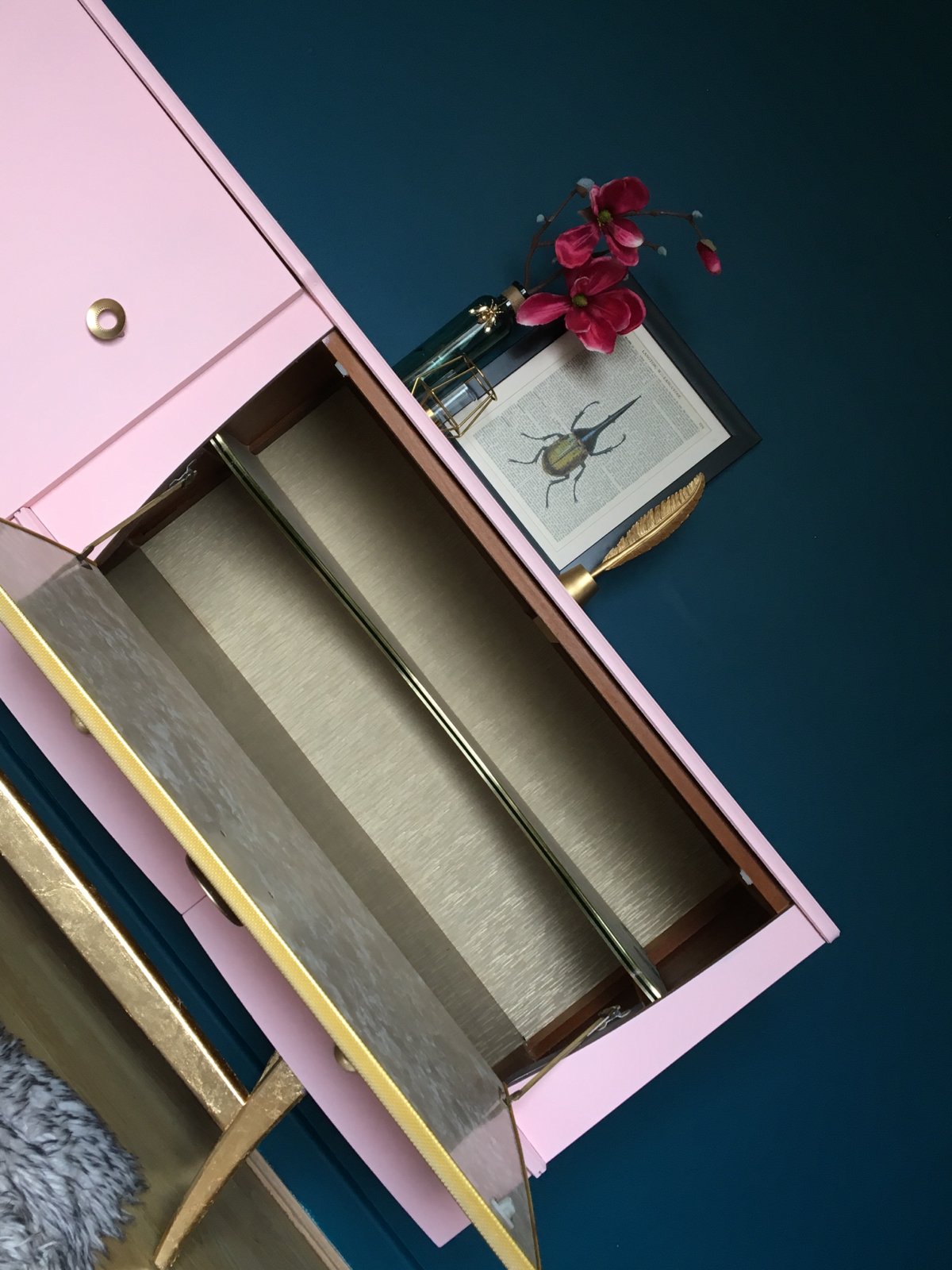 Image of A mid century modern drinks sideboard in pink & gold