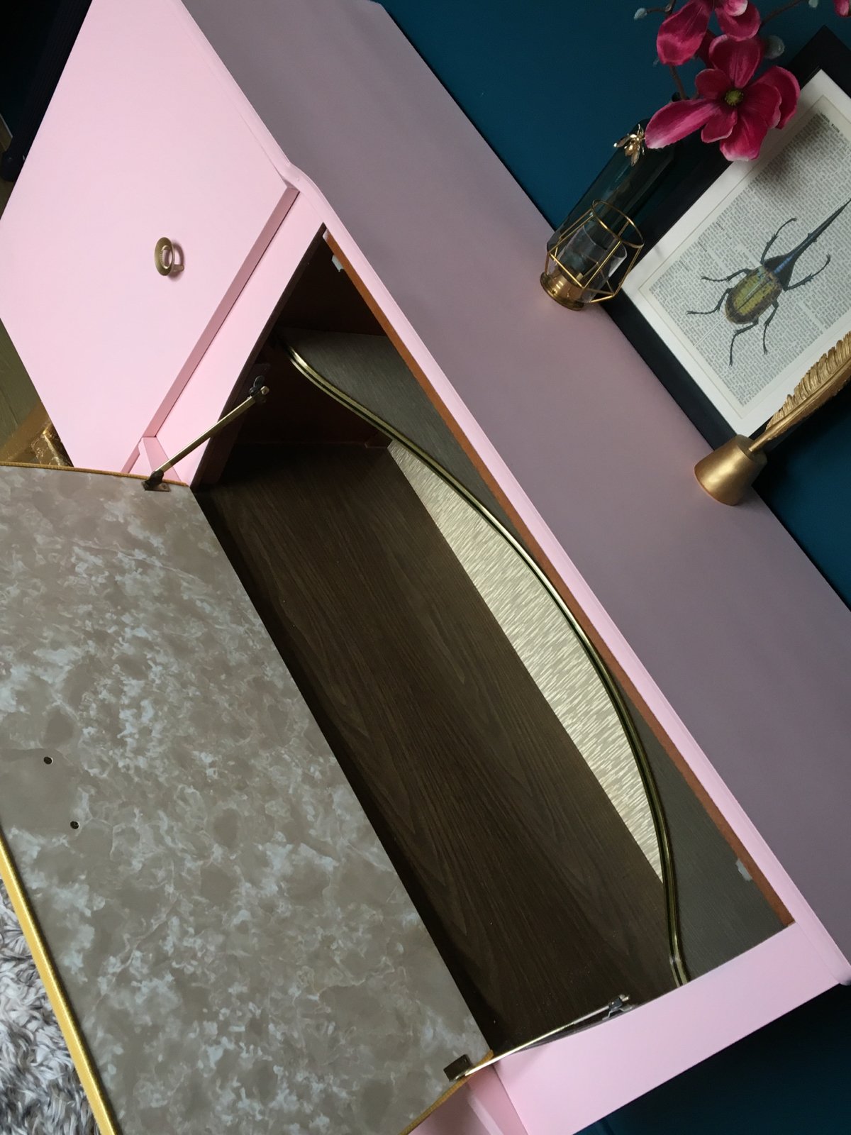 Image of A mid century modern drinks sideboard in pink & gold