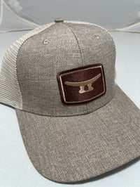 Brown embroidery patch on slate beige hat 