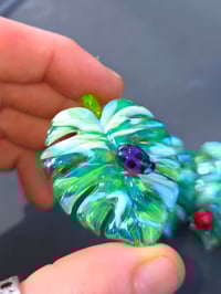 Image 2 of Uv reactive Variegated monstera leaf pendant with purple ladybug 