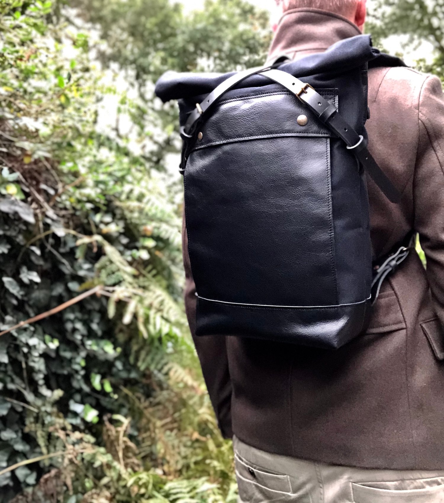 Image of Black backpack medium size rucksack in waxed canvas, with leather front pocket and bottom