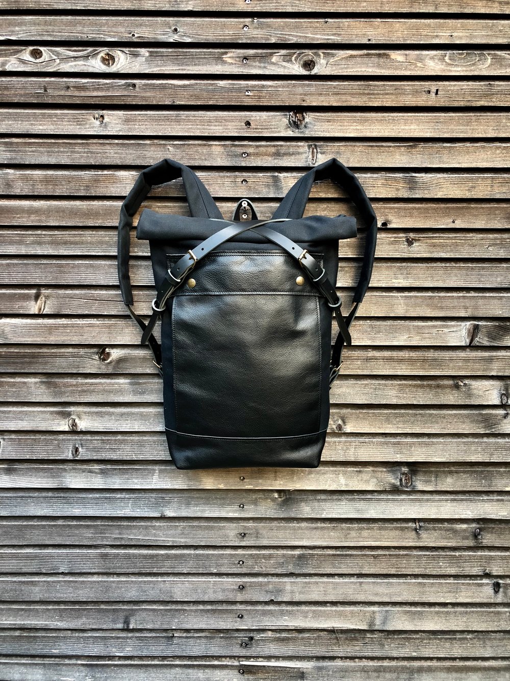 Image of Black backpack medium size rucksack in waxed canvas, with leather front pocket and bottom