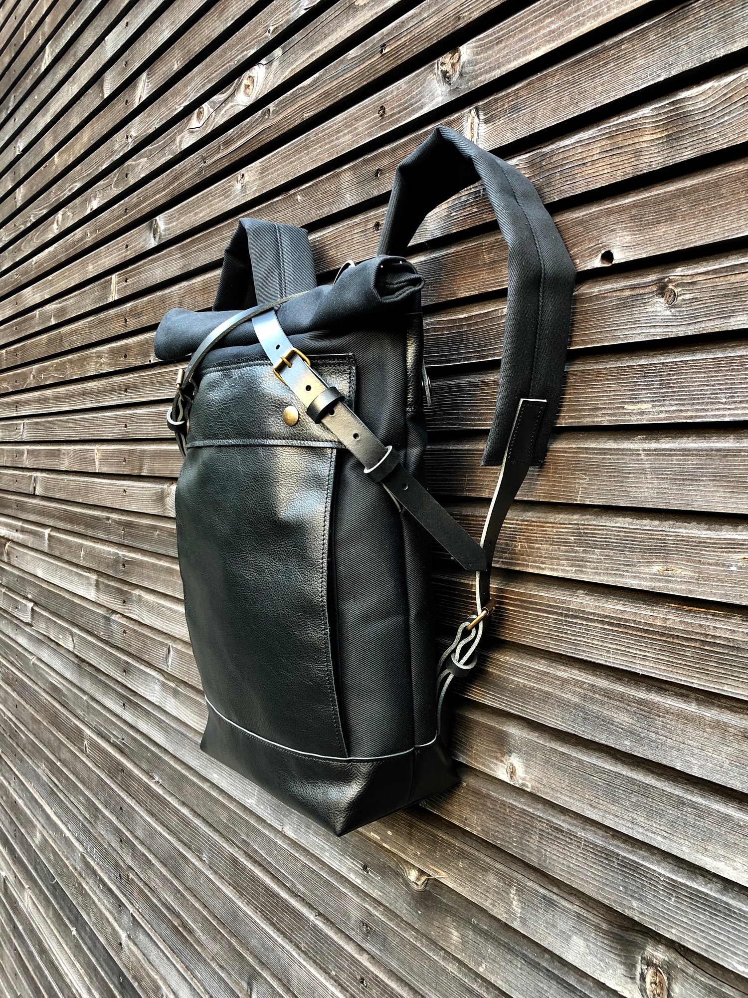 Image of Black backpack medium size rucksack in waxed canvas, with leather front pocket and bottom
