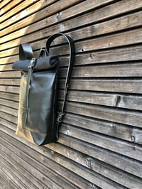 Image 5 of Black leather backpack with waxed canvas roll to close top