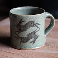 Image 1 of Hare and Rook Mug. Green Celadon glaze.