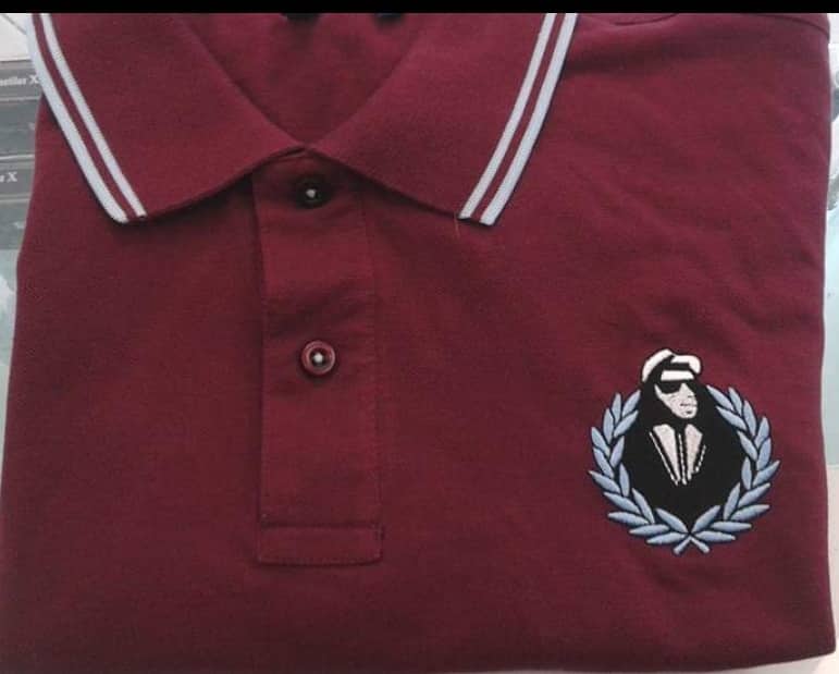 Image of walt jabsco in wreath on burgundy and sky blue polo