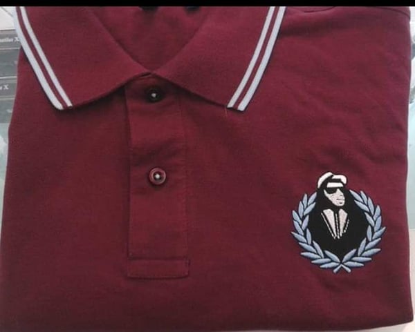 Image of walt jabsco in wreath on burgundy and sky blue polo