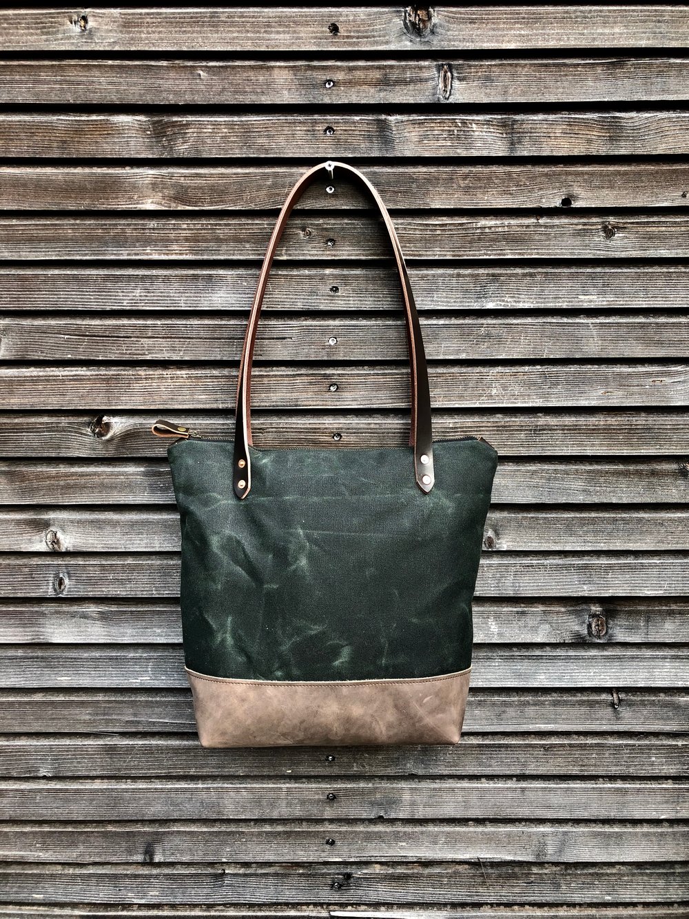 Waxed canvas tote bag with leather handles and zipper closure ...