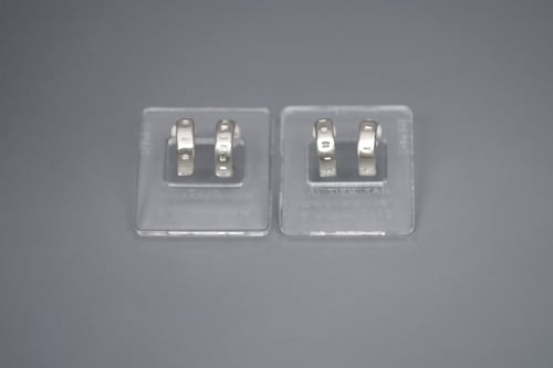 Image of thin round silver earrings with inscription in Latin