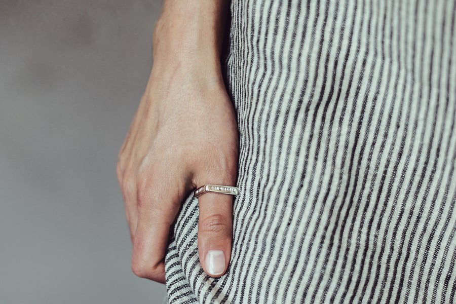 Image of polished  silver square ring with inscription in Latin