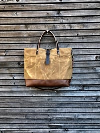 Image 1 of  Tote bag in waxed canvas with leather bottom and cross body strap