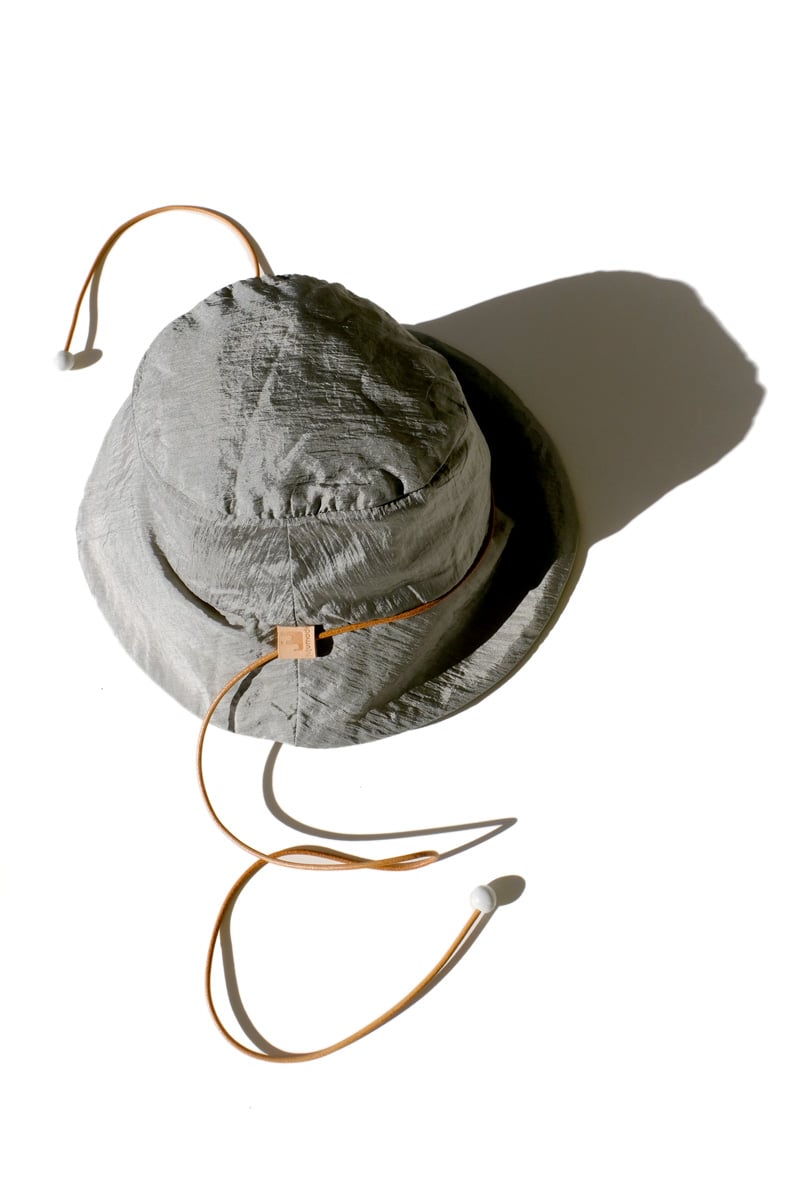 Image of reversible silver nylon bucket hat