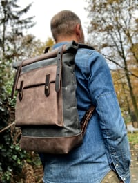 Image 1 of Waxed canvas backpack with roll up top and hand waxed leather bottom and outside pocket