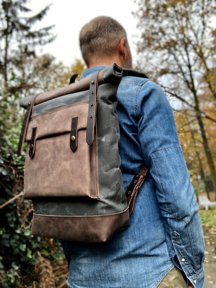 Image of Waxed canvas backpack with roll up top and hand waxed leather bottom and outside pocket