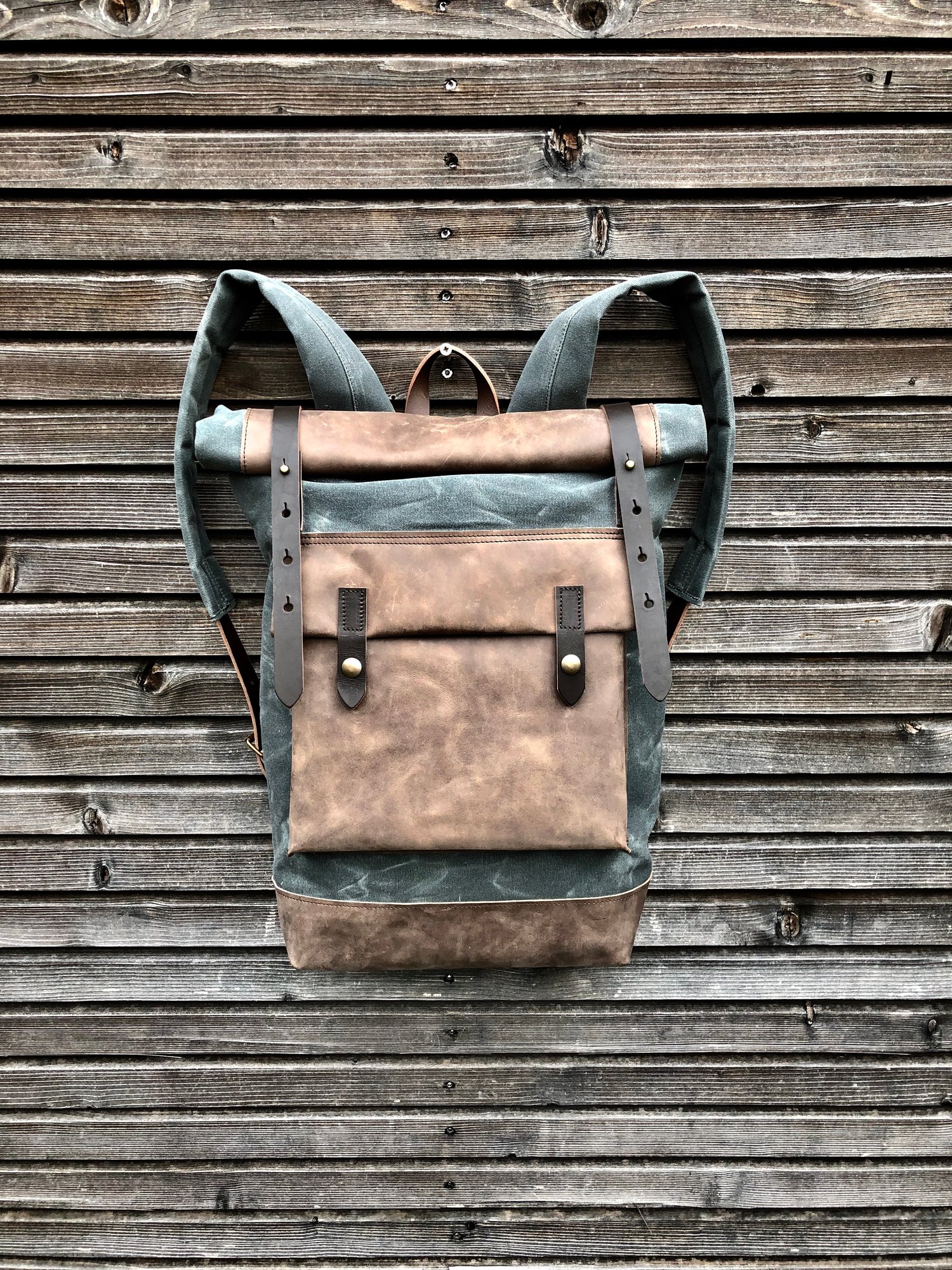 Image of Waxed canvas backpack with roll up top and hand waxed leather bottom and outside pocket
