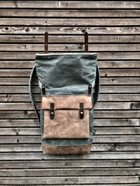 Image 4 of Waxed canvas backpack with roll up top and hand waxed leather bottom and outside pocket