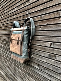Image 5 of Waxed canvas backpack with roll up top and hand waxed leather bottom and outside pocket