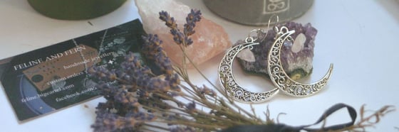 Image of crescent moon rose quartz earrings