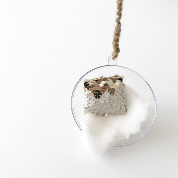 Image of Hanging bubble chair with white shag throw and rope 