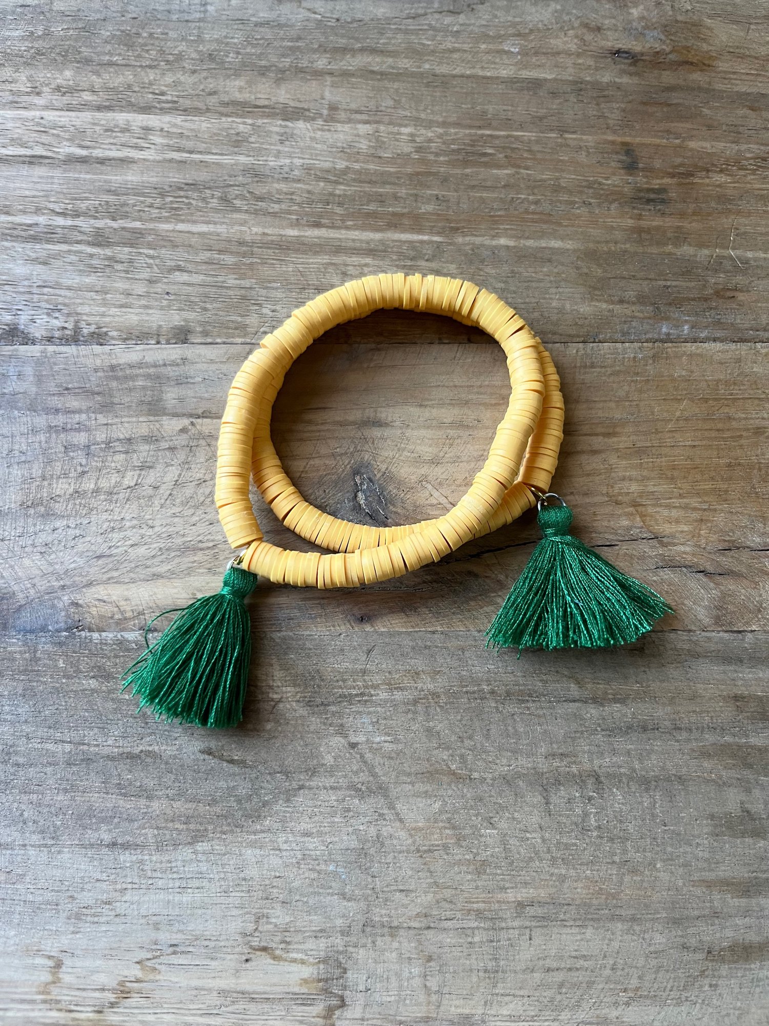Image of Gold with green tassel bracelet