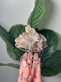 Image 1 of  SMOKEY RUTILE IN QUARTZ CLUSTER ON STAND M