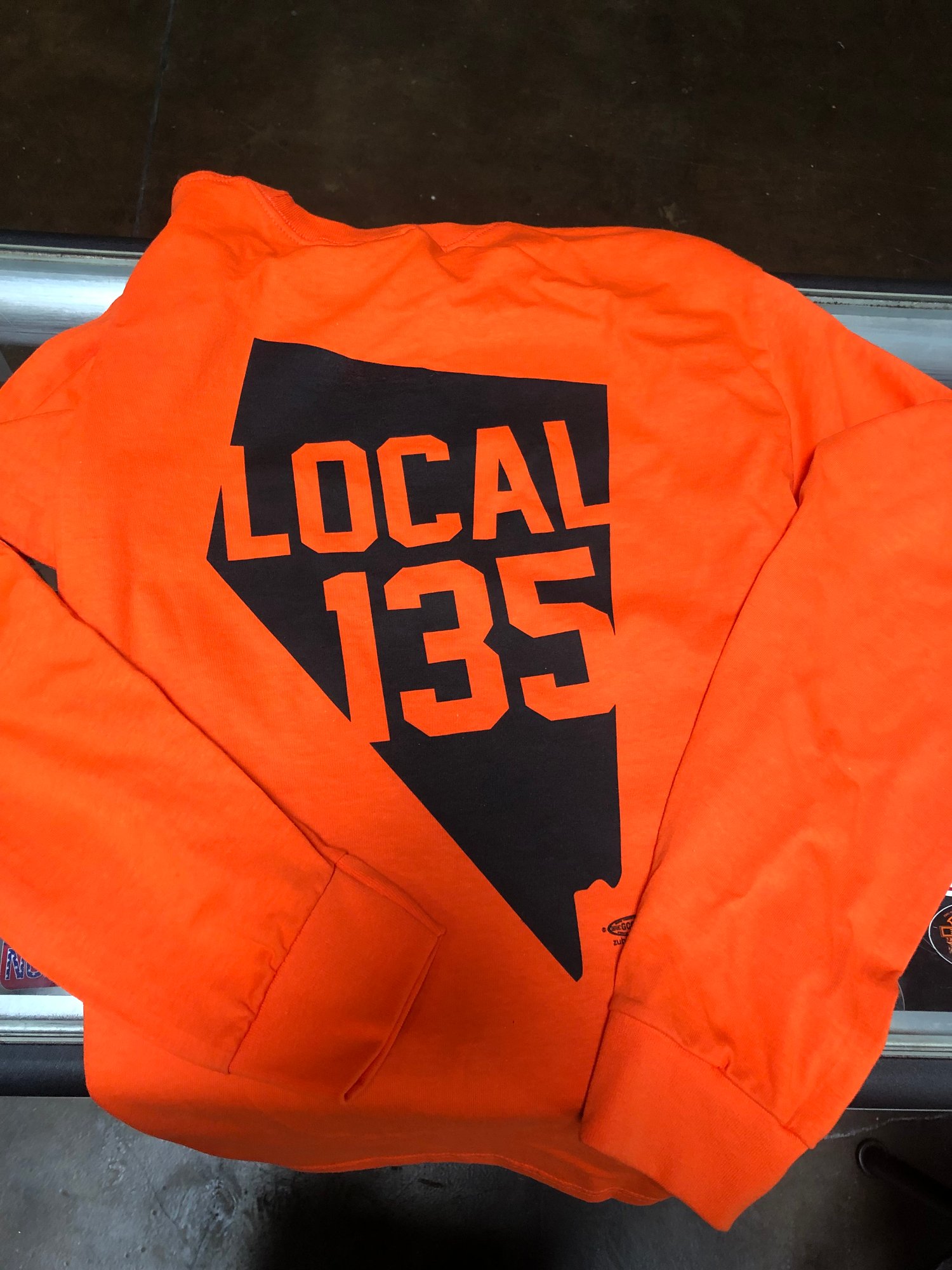 Image of Orange long sleeve Nevada shirt. 