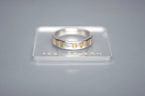 Image of silver classical ring with gold plated letters and inscription in Latin
