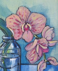 Image 1 of Pink orchids in a glass jar by candle light