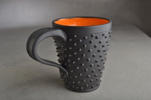 Image of Spiky Mug Gun Metal Black and Orange Made To Order By Symmetrical Pottery