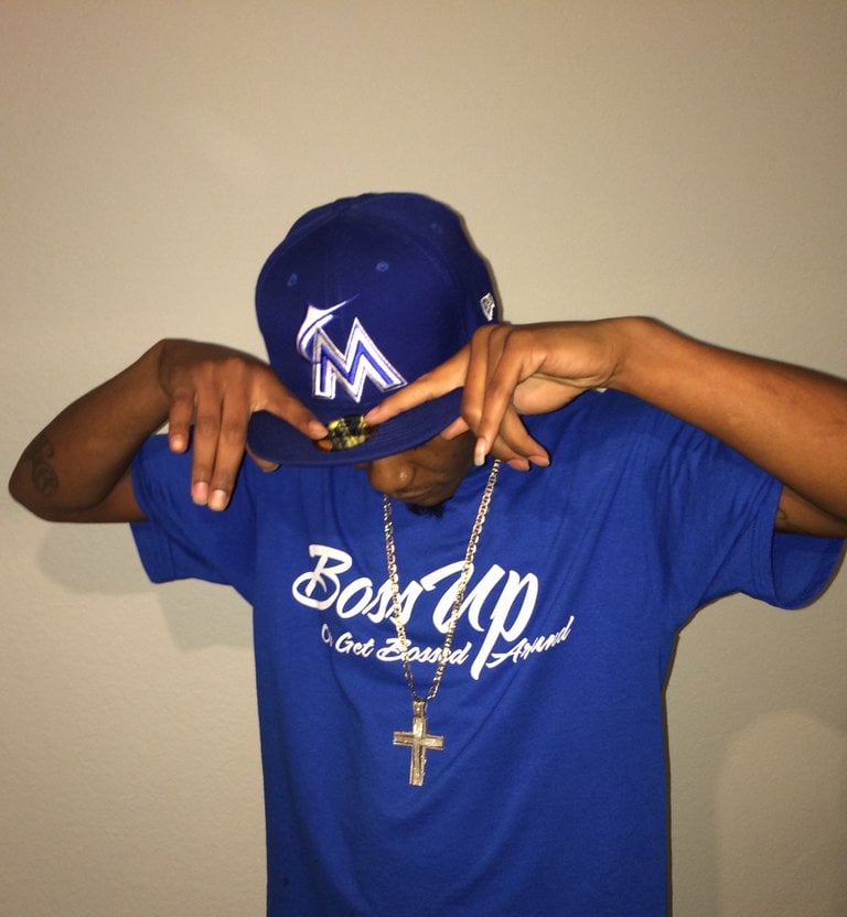 Image of Our red or royal blue signature t-shirts with “BossUp Get Bossed Around” printed in white.
