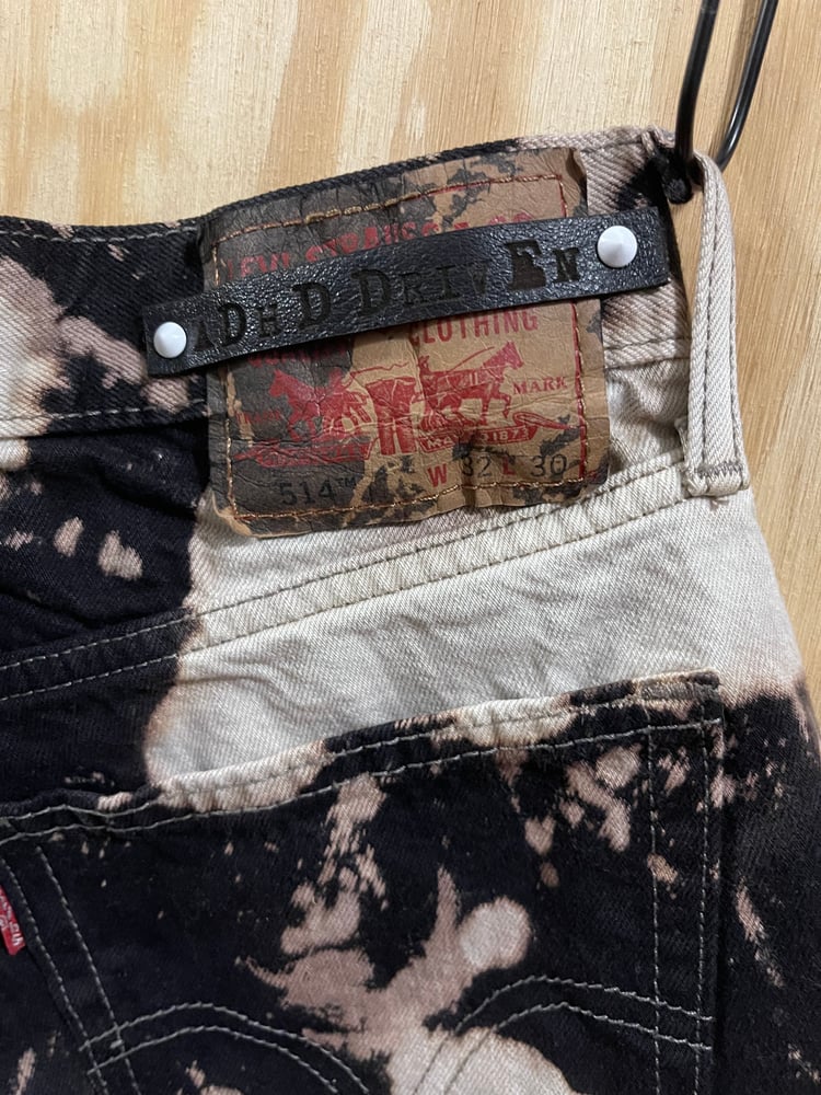 Image of Black splattered Levis 