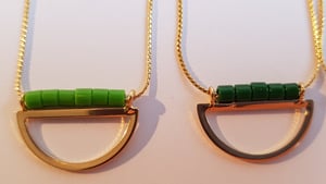 Image of Lucía. Collar corto con media luna dorada y abalorios de cristal.