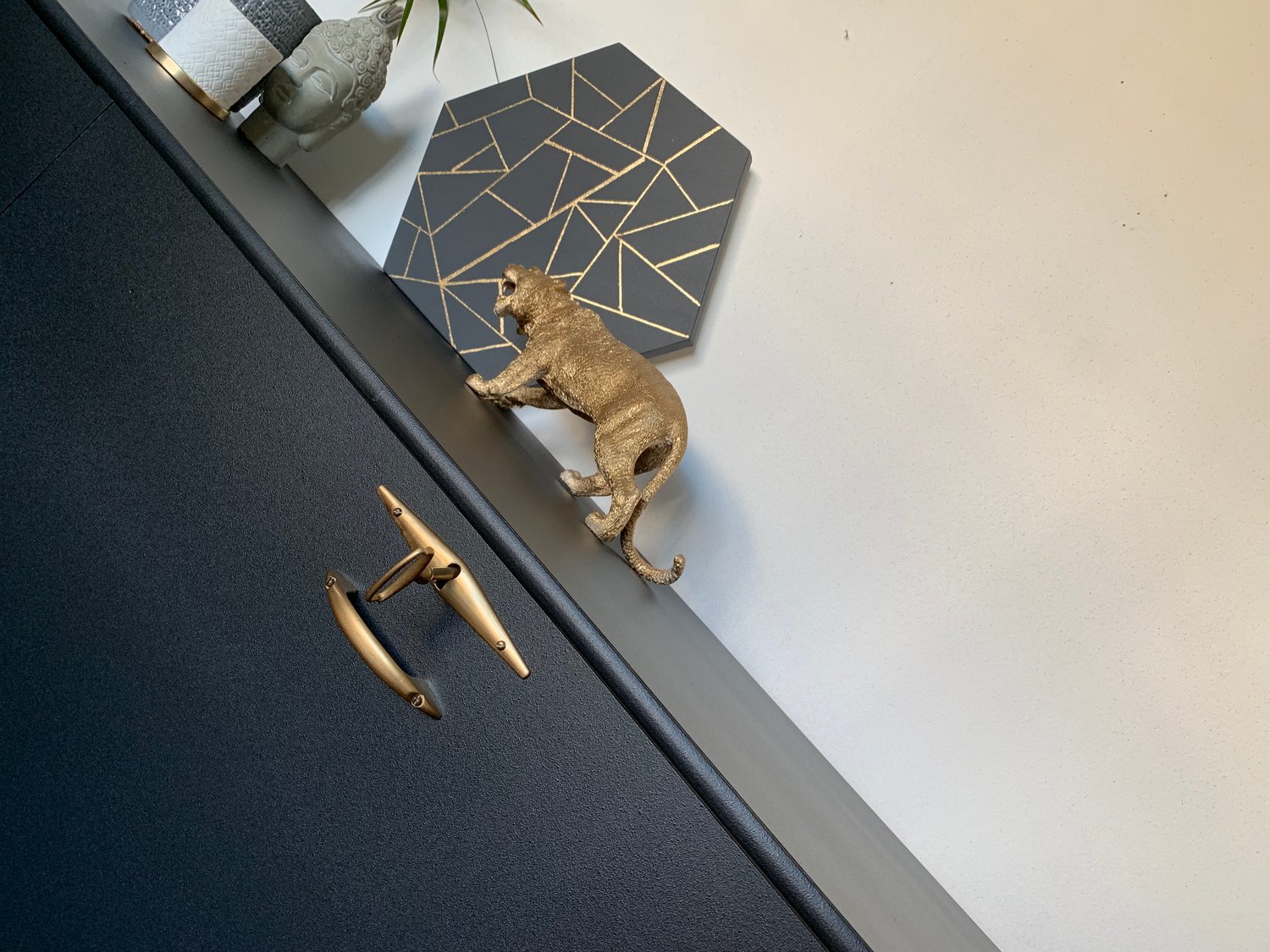 Image of A black and gold drinks sideboard with key.