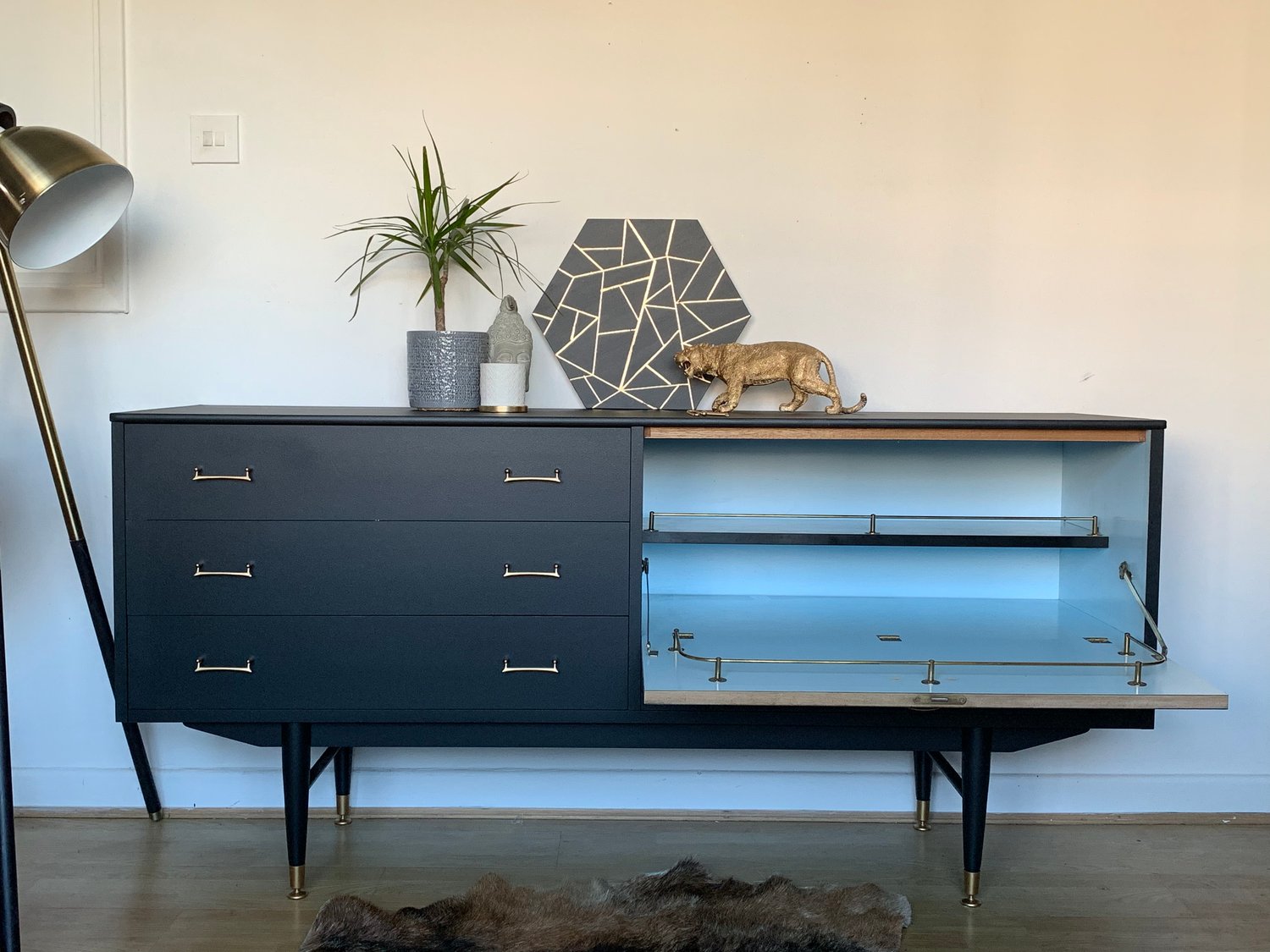 Image of A black and gold drinks sideboard with key.