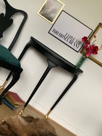 Image 2 of Black half moon with gold leaf feet.