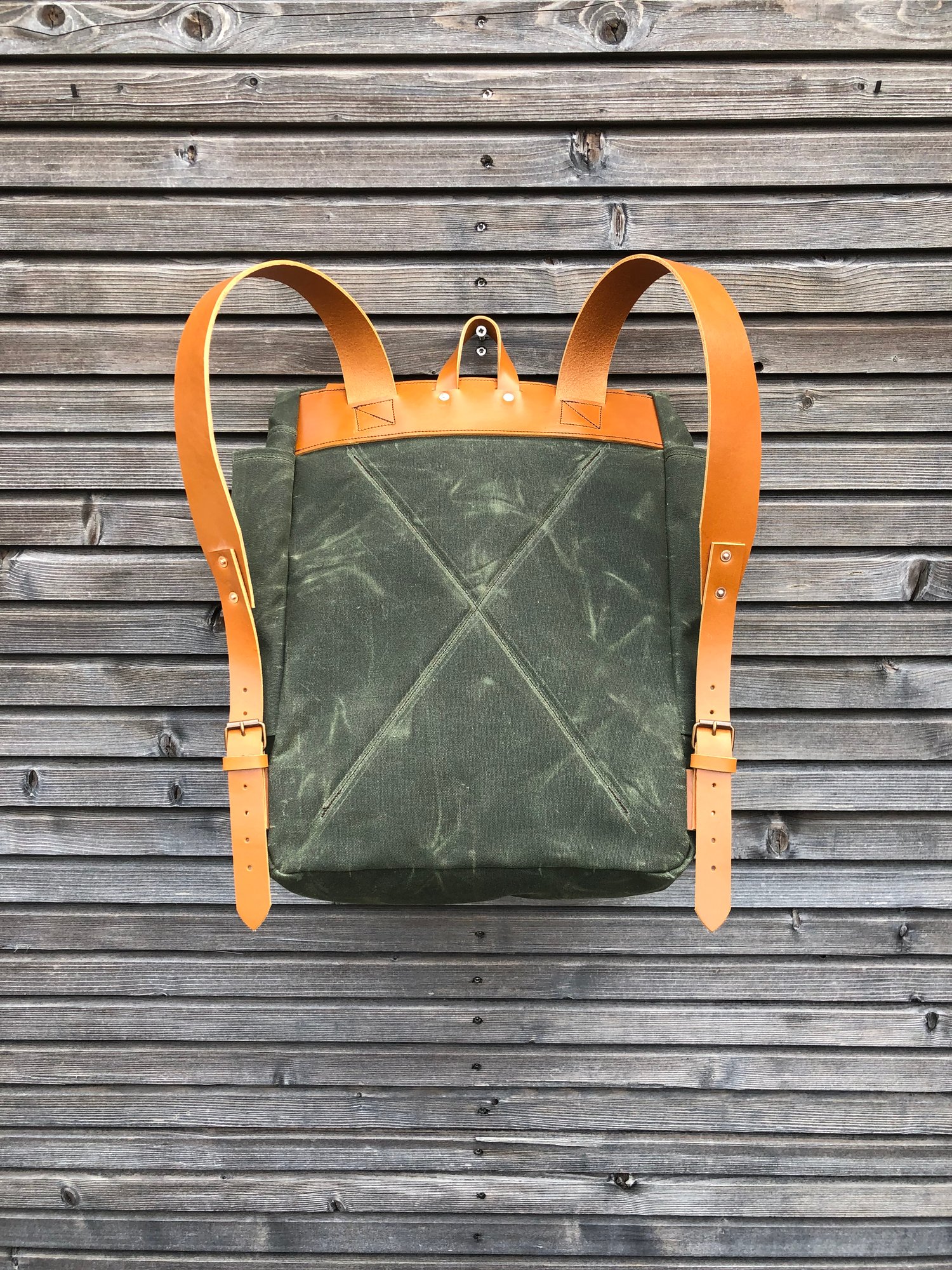 Image of Waxed canvas backpack with roll to close top and vegetable tanned leather shoulderstrap 