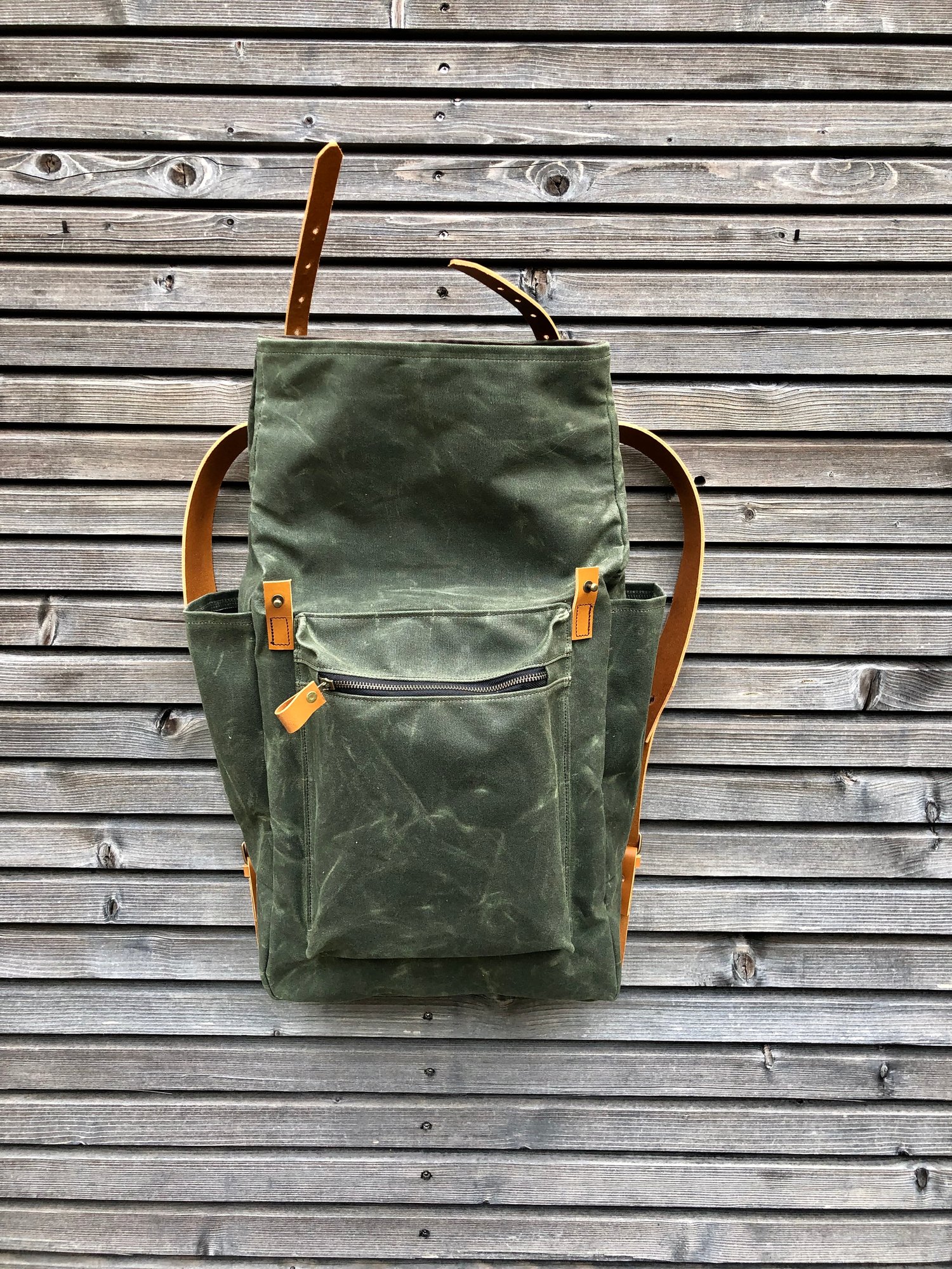 Image of Waxed canvas backpack with roll to close top and vegetable tanned leather shoulderstrap 