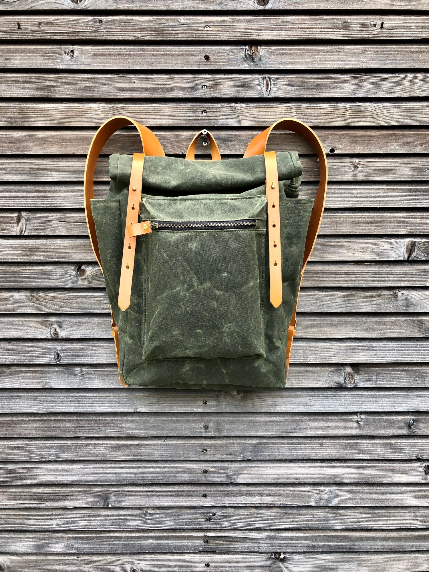 Image of Waxed canvas backpack with roll to close top and vegetable tanned leather shoulderstrap 