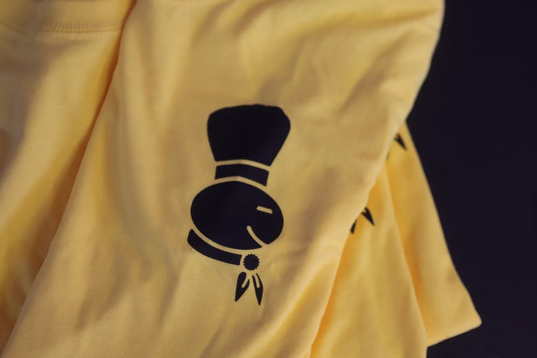 Image of Yellow Doughmanland logo tee