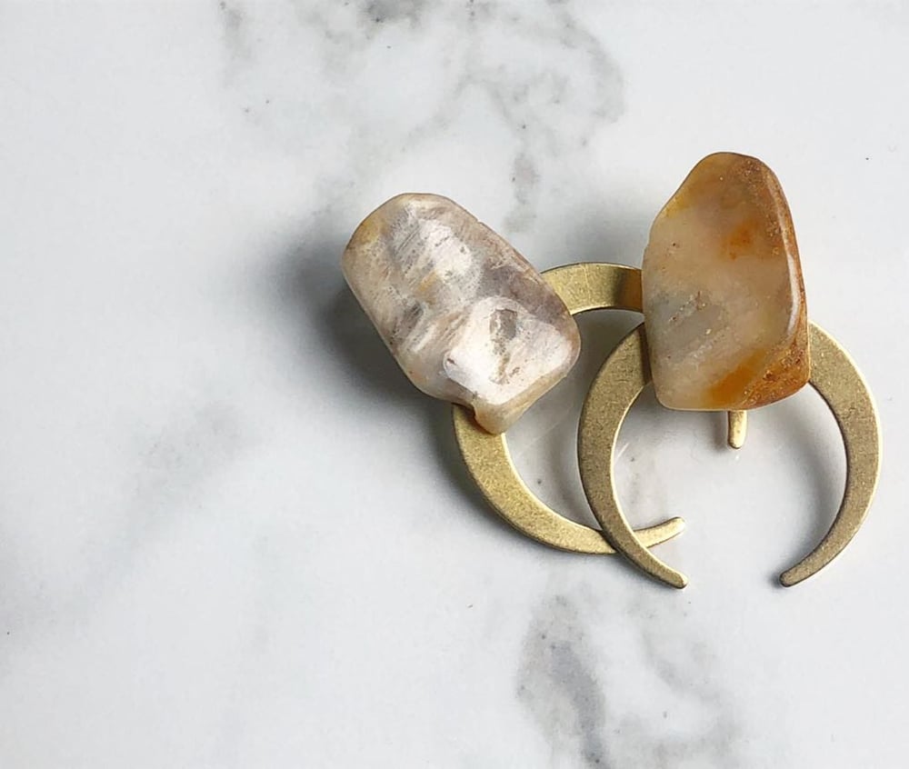 Image of thin brass moons + stone