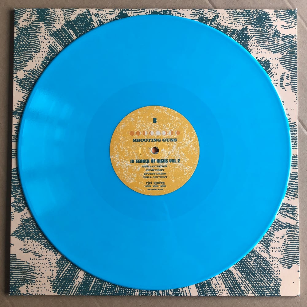 THE BAND WHOSE NAME IS A SYMBOL / SHOOTING GUNS 'In Search Of Highs Vol 2' Blue Vinyl LP