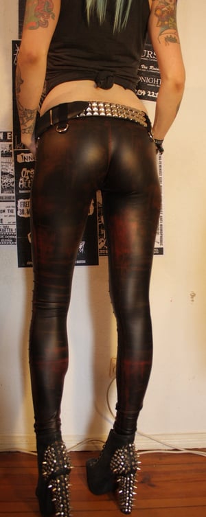 Image of Red-stained fauxleather pants with details