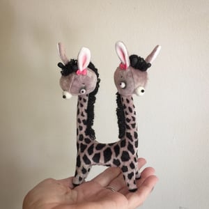 Image of May and June the Two-headed Tiny Giraffe Sisters